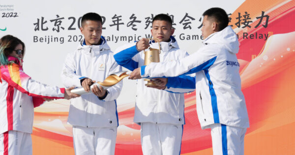 Des athlètes chinois allument la flamme olympique.