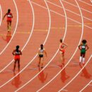 Des athlètes femmes sur une piste de course.